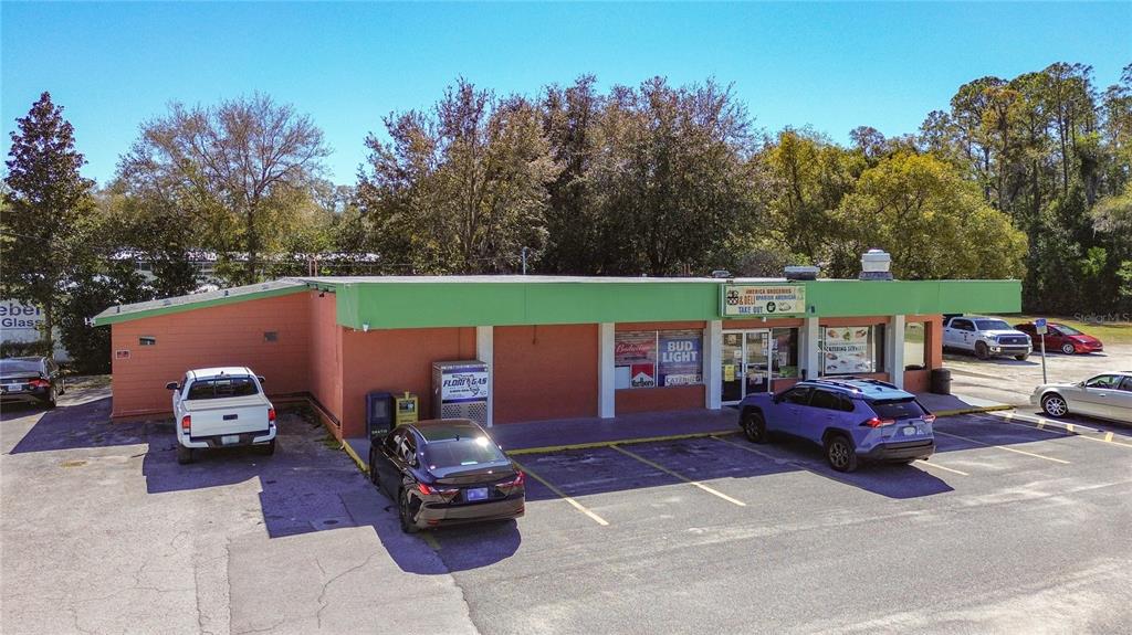 An aerial view of a single-story commercial building with a green roof and orange walls — 3030 W GULF TO LAKE HIGHWAY, LECANTO, FL