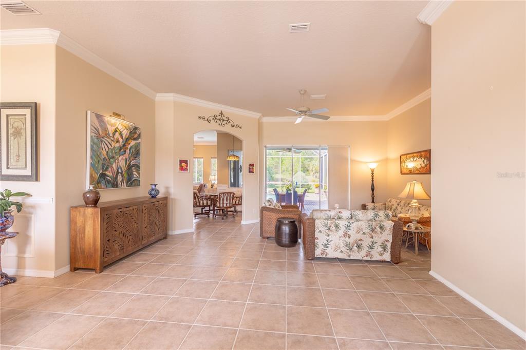 A kitchen features light wood cabinets, stainless steel appliances, a center island, and tile flooring — 1626 E GATE DANCER CIRCLE, INVERNESS, FL