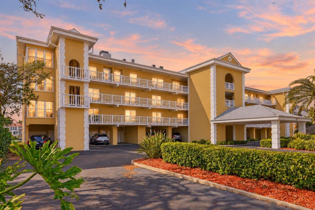 An elevated view of a swimming pool, boat docks, and a canal with residential homes — 544 PINELLAS BAYWAY S UNIT TH13, TIERRA VERDE, FL