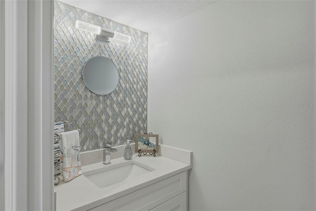 A white front door labeled 205 opens onto a covered outdoor walkway with yellow walls — 544 PINELLAS BAYWAY S UNIT TH13, TIERRA VERDE, FL