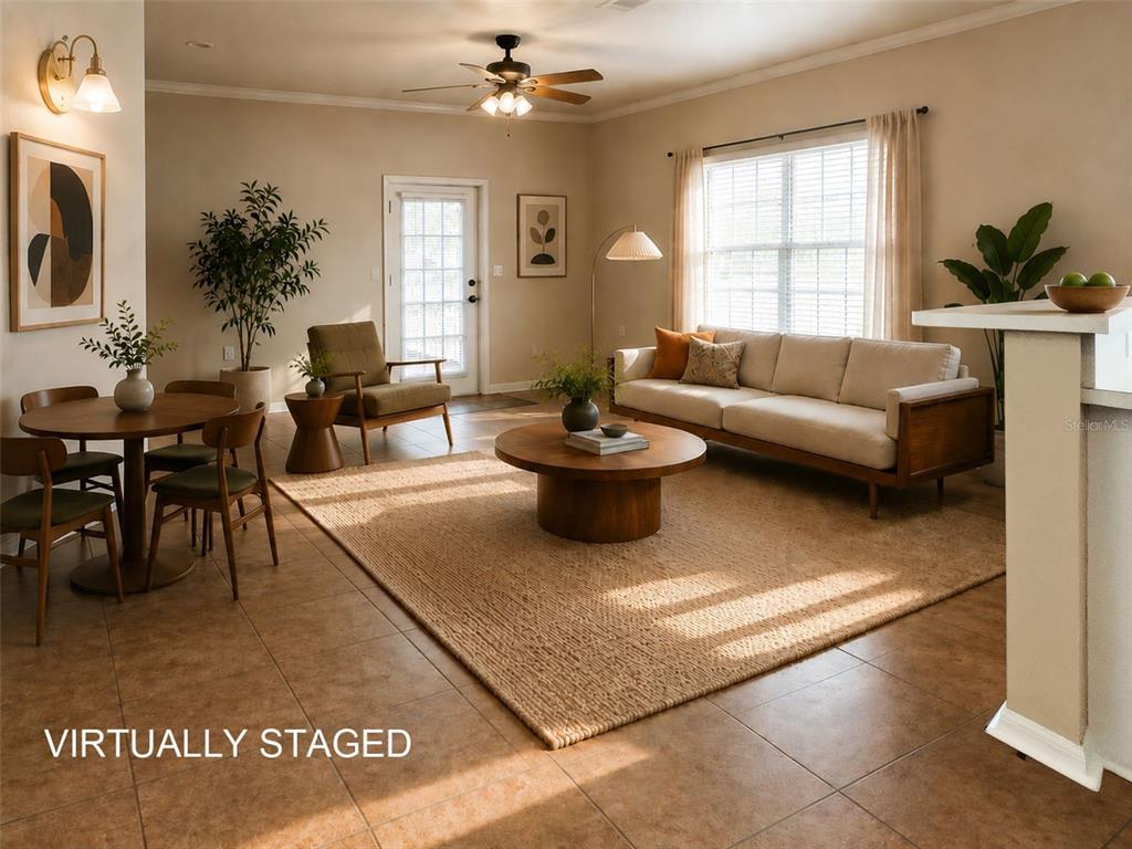 A virtually staged living and dining area features tile floors, a ceiling fan, and furniture — 4806 NW 77TH ROAD, GAINESVILLE, FL