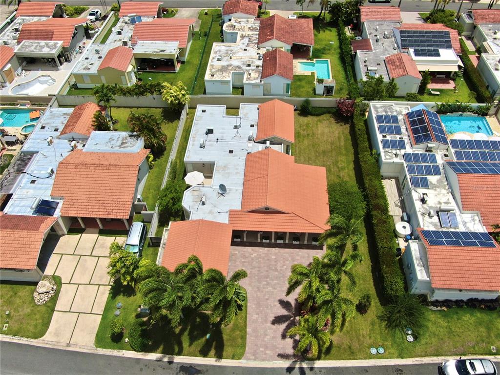 A single-story house with a beige exterior, palm trees, and a landscaped front yard — 302 CAMINO DE LOS CEDROS, DORADO, PR