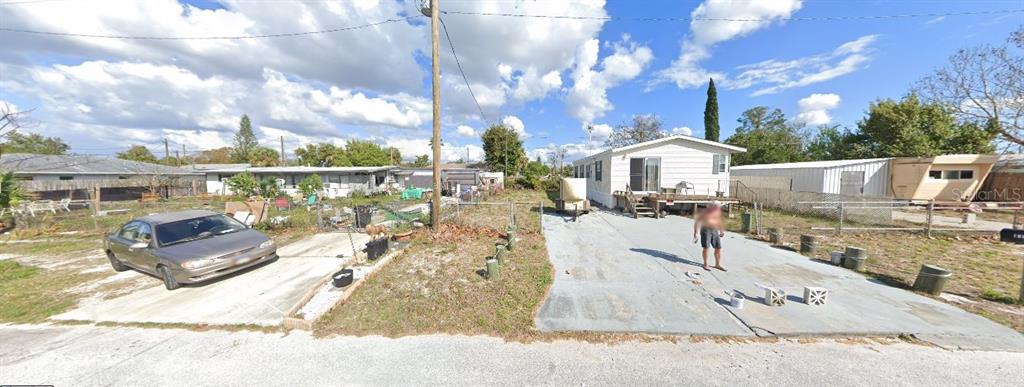 A street-level view shows two mobile homes with concrete driveways and a parked sedan — 13012 AVON STREET, HUDSON, FL