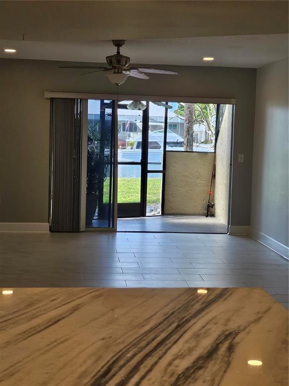 A view from a kitchen counter looking toward a living room with a sliding glass door — 1028 APOLLO BEACH BOULEVARD UNIT 19, APOLLO BEACH, FL