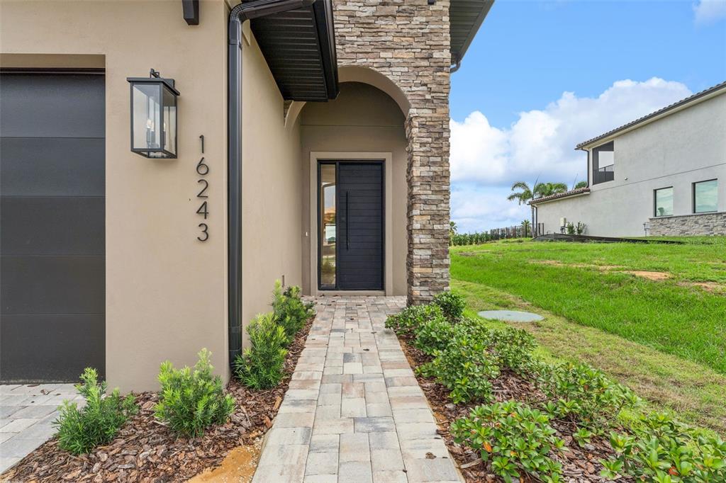 A view of a golf course with palm trees and a large sandy bunker area — 16243 VETTA DRIVE, MONTVERDE, FL