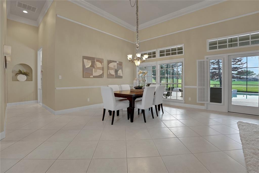 A living room features a sectional sofa, two armchairs, a coffee table, and large windows — 600 CHOCKTAW STREET, LAKE MARY, FL
