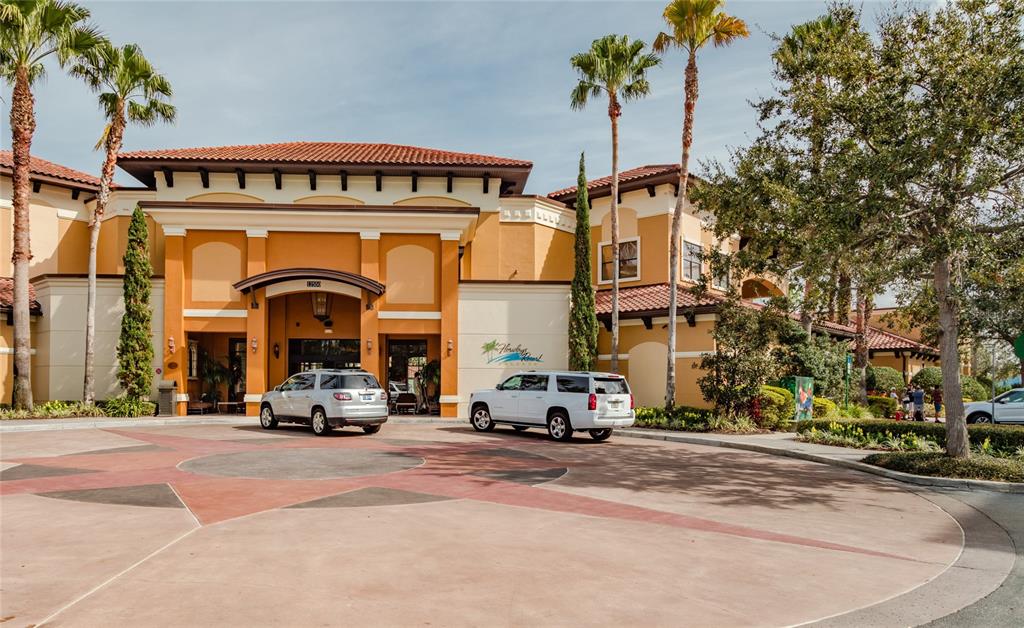 A two-story building with a terracotta roof and palm trees in front of a driveway — 12544 FLORIDAYS RESORT DRIVE UNIT 508B, ORLANDO, FL