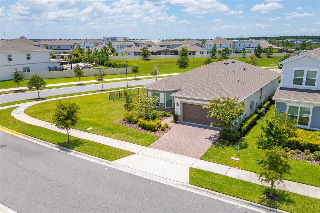 An elevated view of a suburban house with a paved driveway and a grassy yard — 13270 PANAMA BEACH COURT, ORLANDO, FL