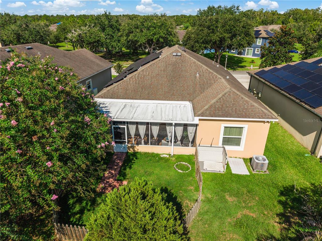 An aerial view of a house with a screened-in back porch and a fenced yard — 2843 JASPER RUN, KISSIMMEE, FL