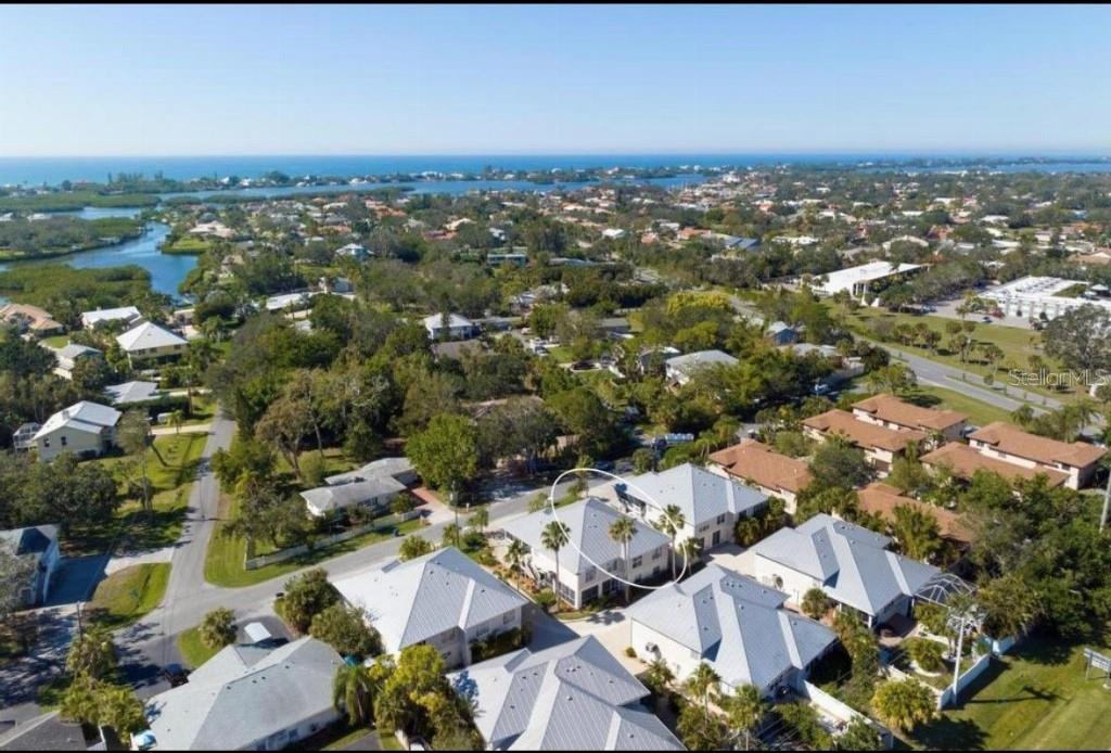 An aerial view shows a residential neighborhood with a circled two-story house and palm trees — 1811 HIGHLAND ROAD, OSPREY, FL