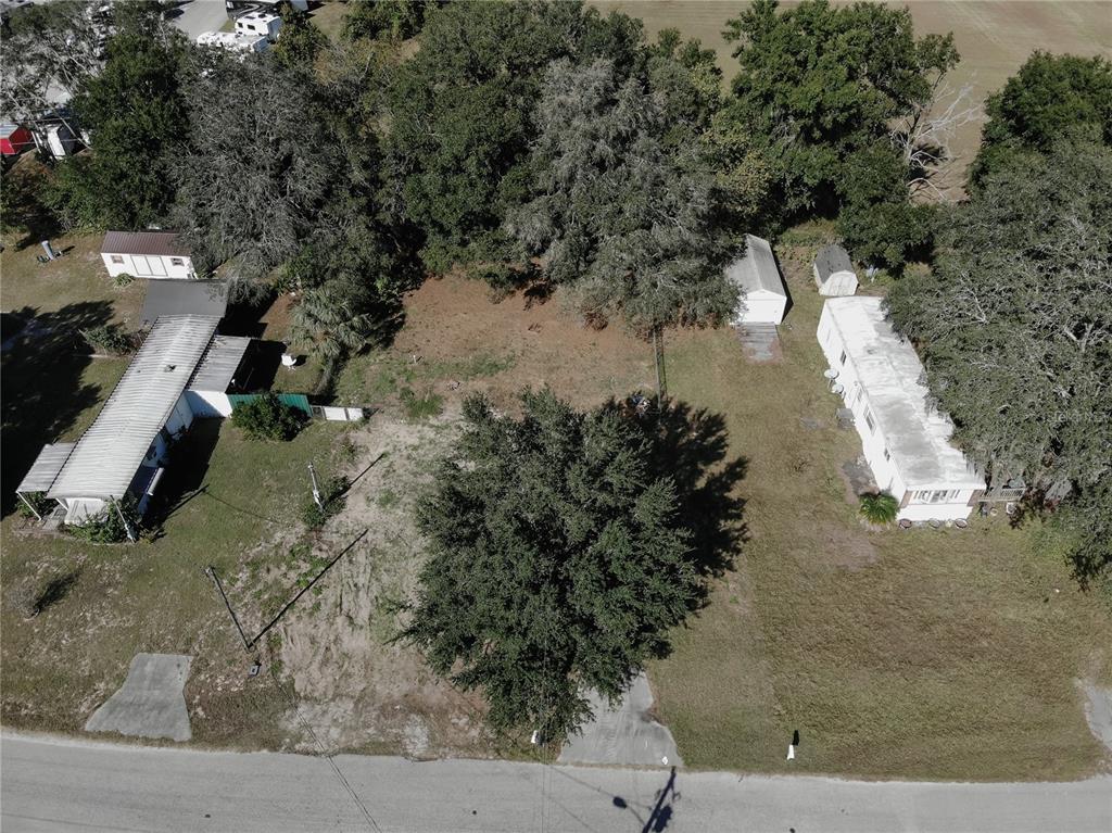 An aerial view shows two mobile homes on a lot with trees and outbuildings — 9251 SE 140TH PLACE, SUMMERFIELD, FL