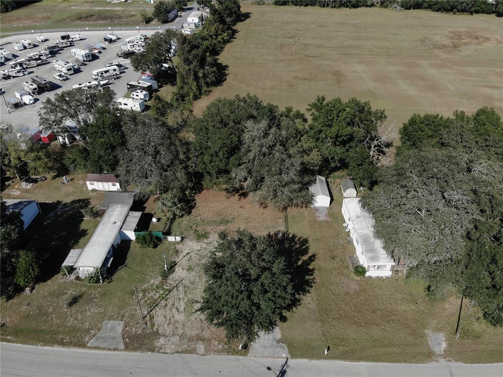 An aerial view shows two mobile homes on a lot adjacent to an RV park — 9251 SE 140TH PLACE, SUMMERFIELD, FL