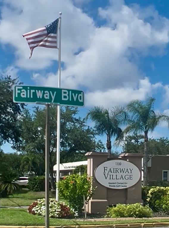 A street sign for Fairway Blvd stands next to a Fairway Village community entrance sign — 1100 BELCHER ROAD S UNIT 304, LARGO, FL