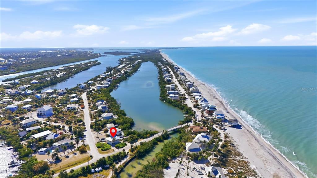 An aerial view shows a coastal neighborhood with a house marked by a red pin — 11 BOCILLA DRIVE, PLACIDA, FL