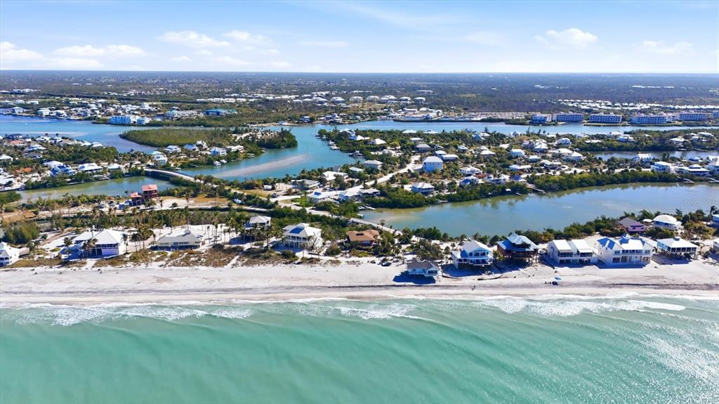 An aerial view of a sandy beach with houses along the coastline and inland waterways — 11 BOCILLA DRIVE, PLACIDA, FL