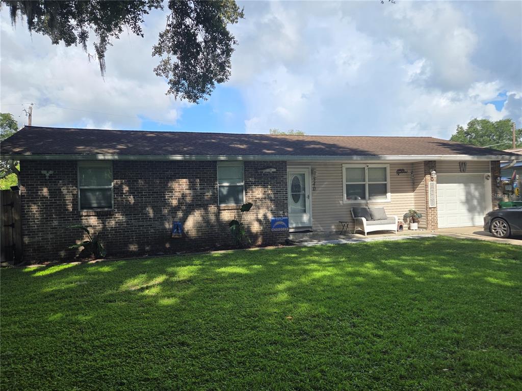 A single-story house with a brick and siding exterior, a front lawn, and an attached garage — 340 S CENTER STREET, ORMOND BEACH, FL