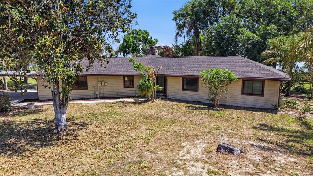 An aerial view shows a house with a red location pin beside a large lake — 410 S RAMONA AVENUE, LAKE ALFRED, FL