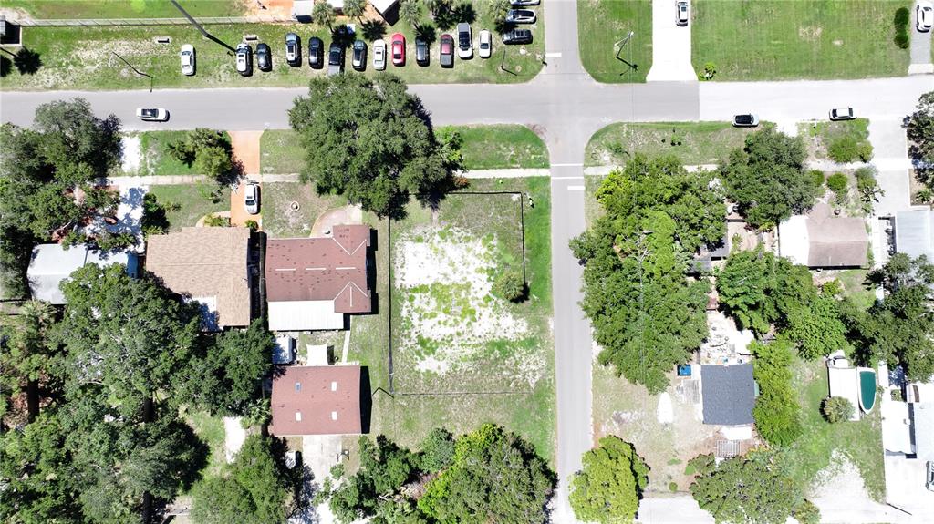 An aerial view shows a vacant residential lot situated between two houses on a street — 5631 23RD AVENUE S, GULFPORT, FL