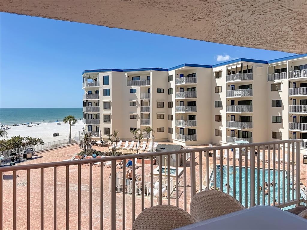 An entryway features tile flooring, a bookshelf, a glass console table, and a mirrored closet — 18400 GULF BOULEVARD UNIT 1312, INDIAN SHORES, FL
