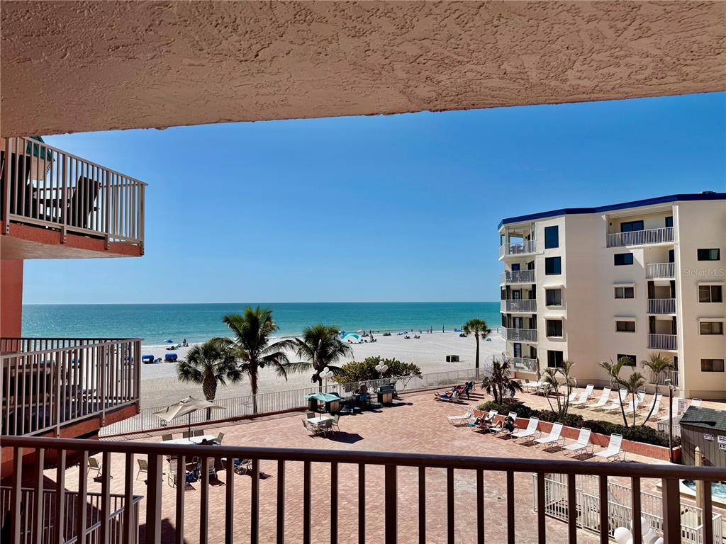 A kitchen features white cabinets, granite countertops, stainless steel appliances, and diagonal floor tiles — 18400 GULF BOULEVARD UNIT 1312, INDIAN SHORES, FL