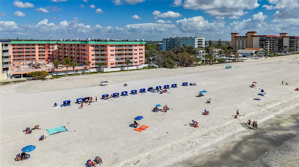 A kitchen with white cabinets, stainless steel appliances, a tiled backsplash, and a dining area — 18400 GULF BOULEVARD UNIT 1312, INDIAN SHORES, FL