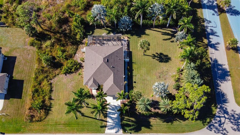 An aerial view shows a house with a screened-in pool area and a large yard — 101 & 103 WAHOO DRIVE, ROTONDA WEST, FL