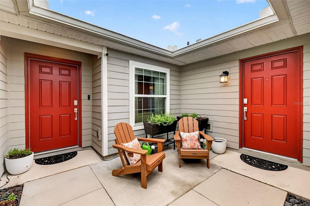 A single-story house with gray siding, a two-car garage, and solar panels on the roof — 5710 ALENLON WAY, MOUNT DORA, FL