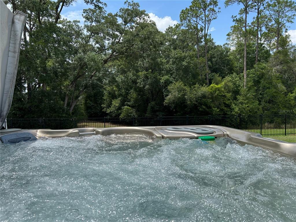 A single-story house with a gray exterior, shingled roof, and a two-car garage — 5710 ALENLON WAY, MOUNT DORA, FL