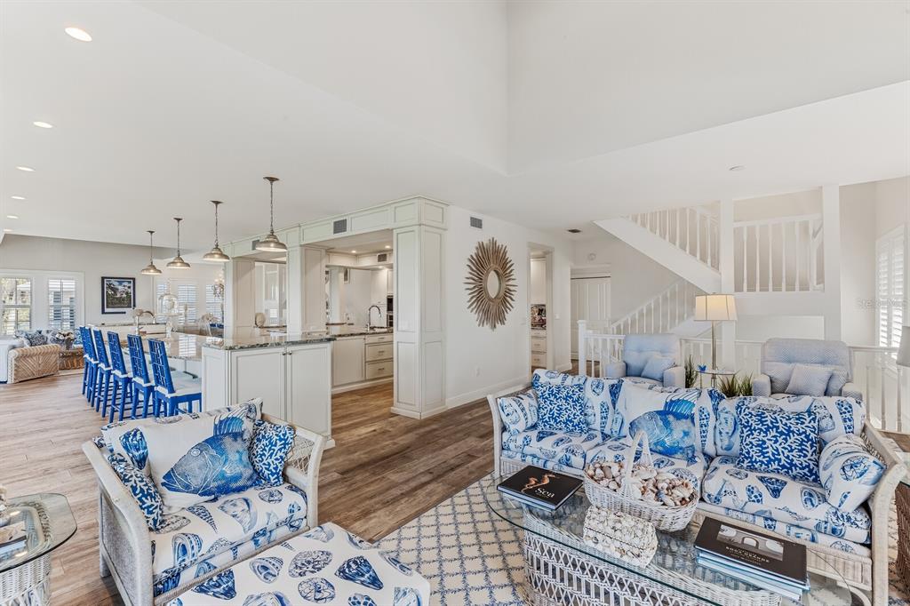 A bright living room and kitchen area features blue and white coastal-themed furniture and decor — 40 SEAWATCH LAKE DRIVE, BOCA GRANDE, FL