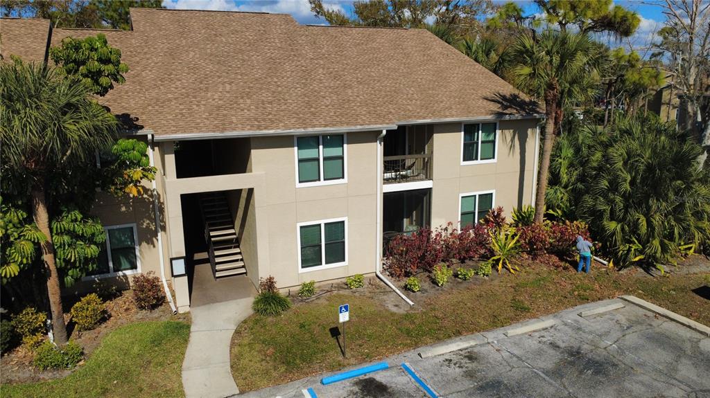 A kitchen with white cabinets and a breakfast bar opens into a dining area — 4040 CROCKERS LAKE BOULEVARD UNIT 1717, SARASOTA, FL