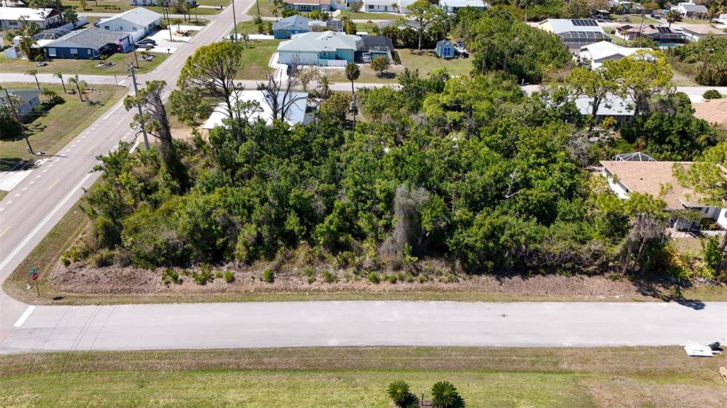 An aerial view shows a vacant, wooded residential lot situated between two paved roads — FUNDY ROAD, VENICE, FL