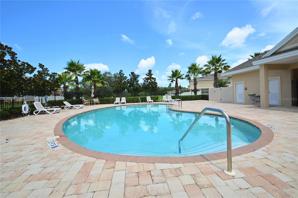 An open-concept living area features tile flooring, a kitchen with wood cabinets, and a bathroom — 11925 GREENGATE DRIVE, HUDSON, FL