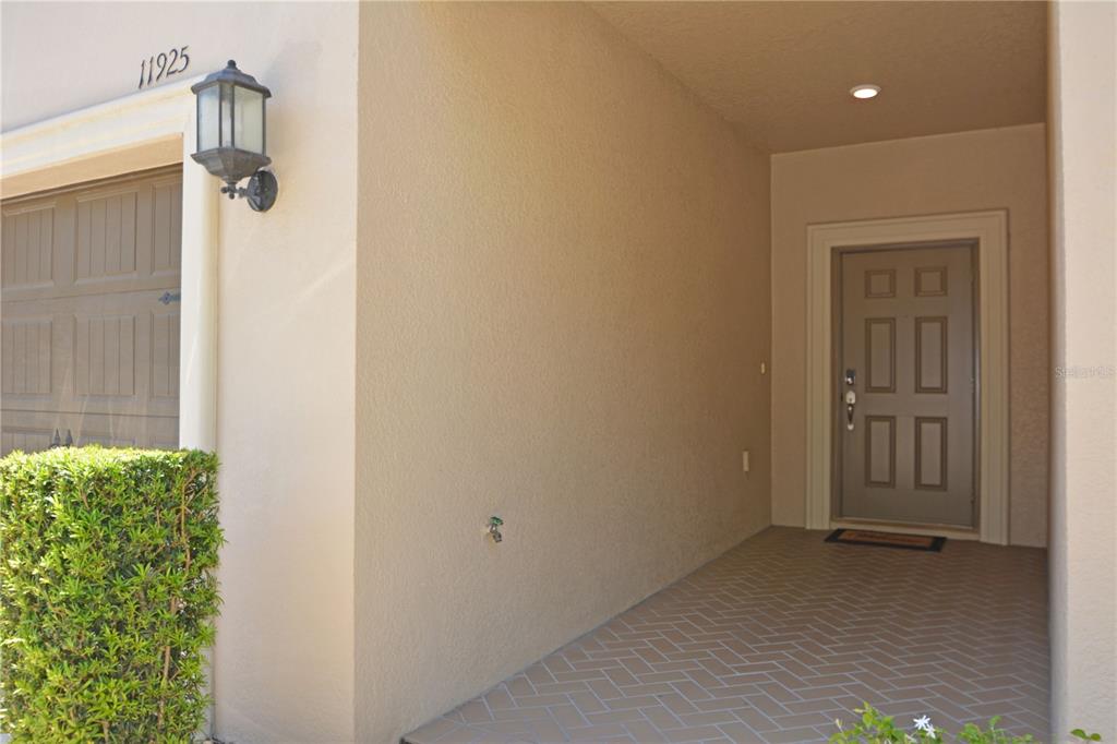A spacious, empty room features light-colored tile flooring, a ceiling fan, and white walls — 11925 GREENGATE DRIVE, HUDSON, FL