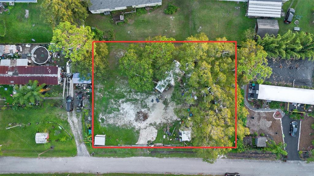 An aerial view shows a rectangular lot with a mobile home surrounded by mature trees — 1ST AVENUE, ORLANDO, FL