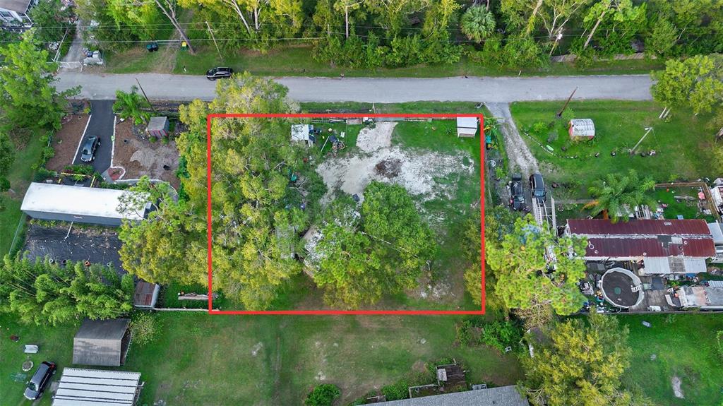 An aerial view shows a rectangular lot with trees and a small structure outlined in red — 1ST AVENUE, ORLANDO, FL