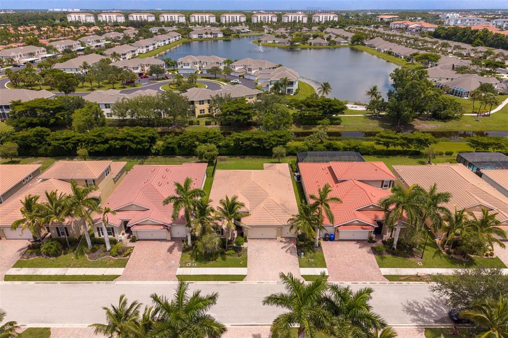An aerial view shows a row of suburban houses with tiled roofs and palm trees — 3987 ASHENTREE COURT, FORT MYERS, FL