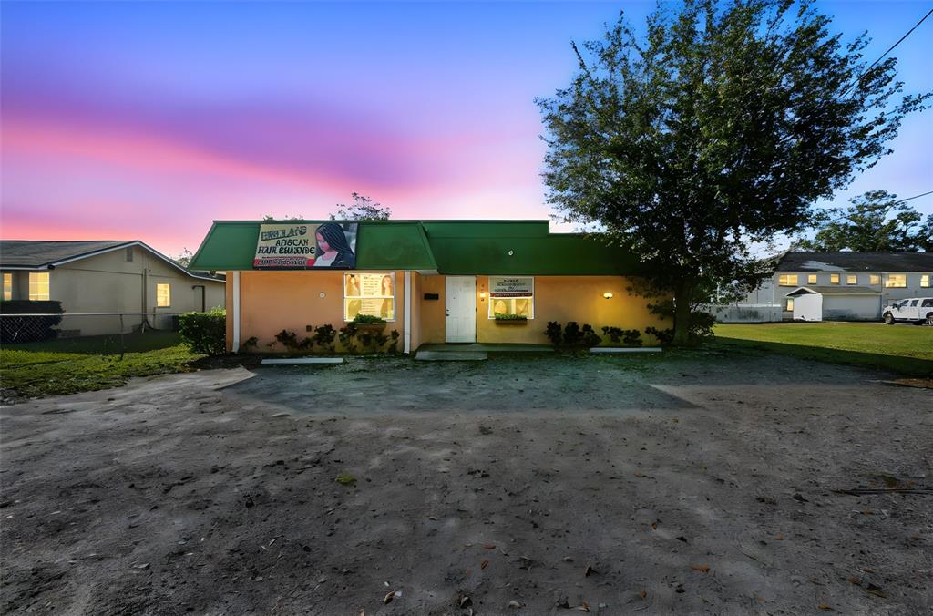 A single-story commercial building with a green roof and a dirt parking lot — 109 E ROBERTSON STREET, BRANDON, FL