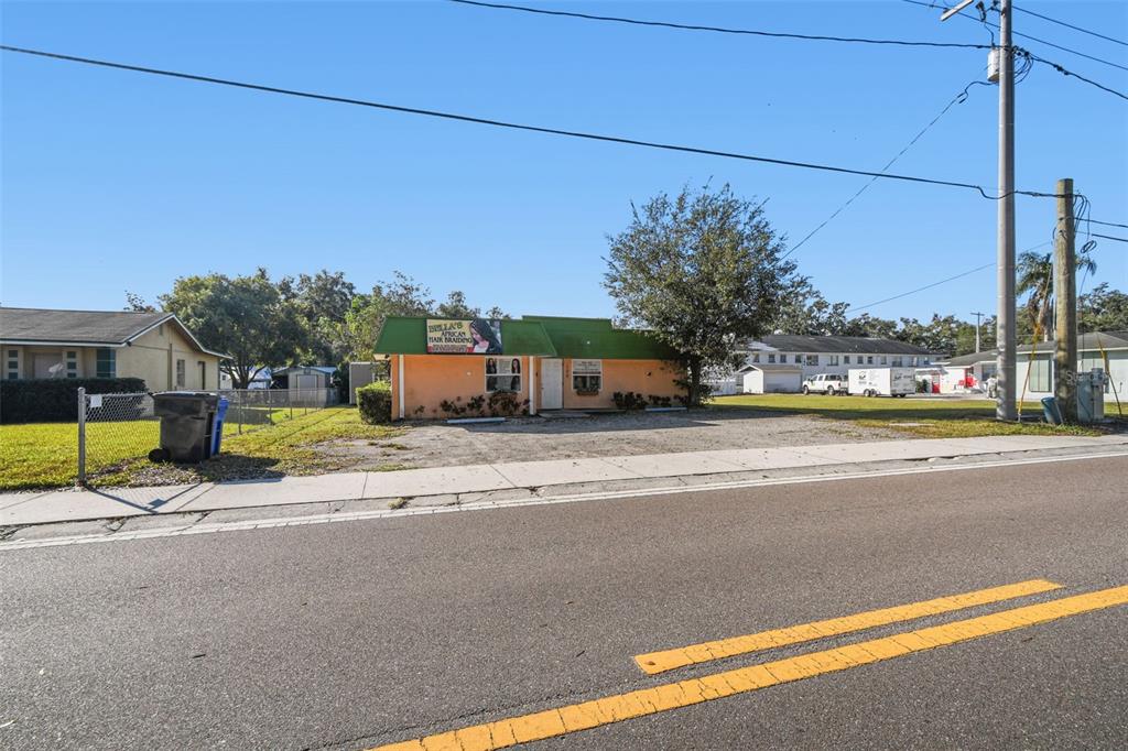A single-story commercial building with a green roof and orange facade sits near a road — 109 E ROBERTSON STREET, BRANDON, FL