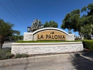 A stone-faced monument sign for La Paloma stands at the entrance of a residential community — 3918 GAVIOTA DRIVE, RUSKIN, FL