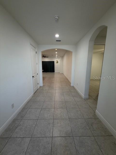 A tiled hallway leads toward an arched opening with a view into a living area — 3918 GAVIOTA DRIVE, RUSKIN, FL