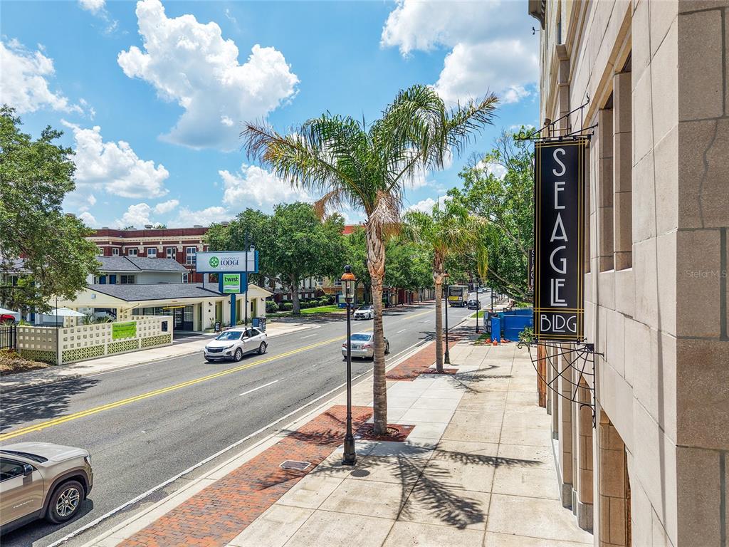 The exterior of the multi-story John F. Seagle Building features a stone facade and palm trees — 408 W UNIVERSITY AVENUE UNIT 7B, GAINESVILLE, FL