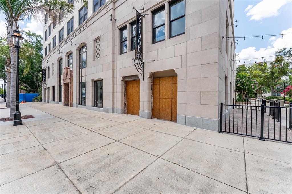 An elevated street view shows a sidewalk, palm trees, and the Seagle Building sign — 408 W UNIVERSITY AVENUE UNIT 7B, GAINESVILLE, FL