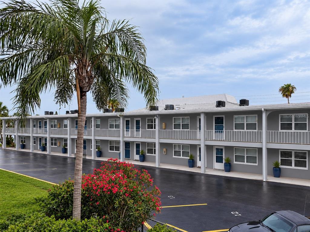 A view of a waterway with docks, boats, and a large apartment building — 9715 HARRELL AVENUE UNIT 14, TREASURE ISLAND, FL
