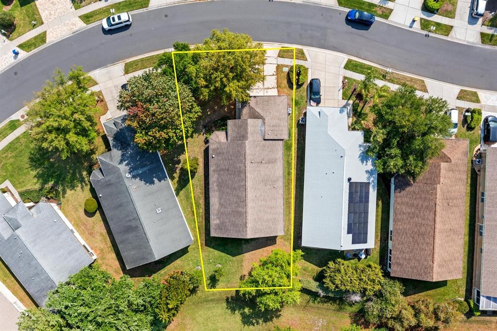 An aerial view shows a residential house with a yellow property boundary outline — 1249 WINDING WILLOW DRIVE, TRINITY, FL