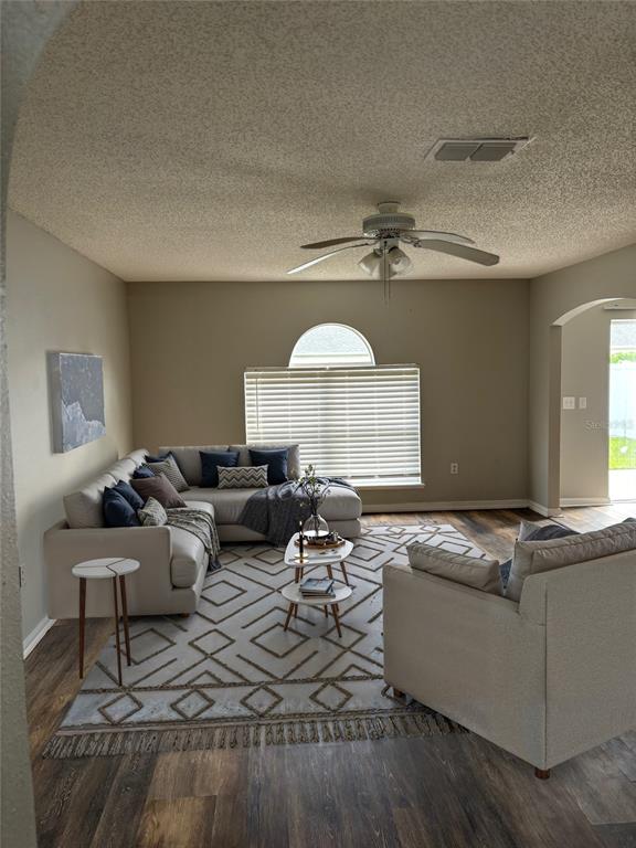 A living room features a sectional sofa, an armchair, a patterned rug, and a ceiling fan — 11102 SUMMER STAR DRIVE, RIVERVIEW, FL