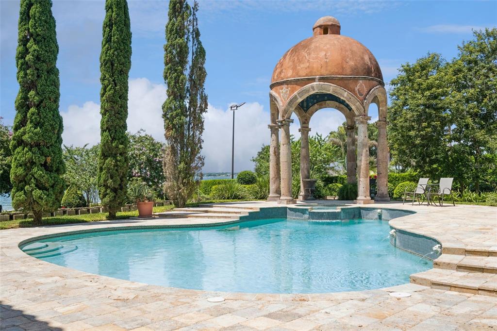 A swimming pool sits in front of a stone gazebo with a domed roof — 2961 LAKEVIEW DRIVE, SEBRING, FL