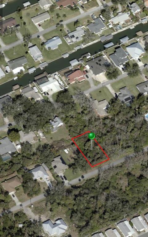 This is an aerial view of a vacant, wooded residential lot outlined in red — POINCIANA ROAD, EDGEWATER, FL