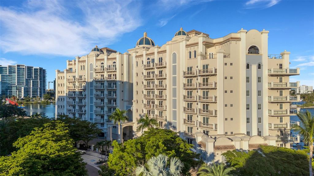 An exterior view of a multi-story residential building with balconies and domed roof accents — 464 GOLDEN GATE POINT UNIT 403, SARASOTA, FL