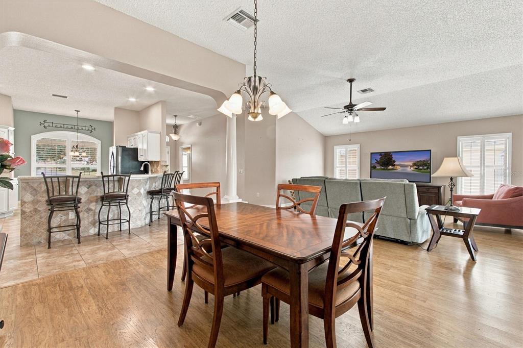 A sunroom with tile floors, ceiling fans, and large windows overlooking a golf course — 2314 CALLAWAY DRIVE, THE VILLAGES, FL
