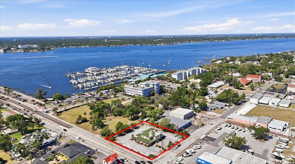 An aerial view shows a commercial property outlined in red near a marina and waterway — 337 US-41 BUS., PALMETTO, FL